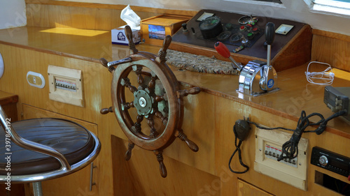 Modern ship control panel with steering wheel and engine accelerators on the captain bridge
