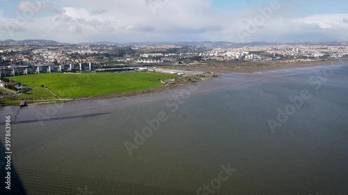Aerial view of countryside around the the Vasco da Gama bridge in Lisbon, with the view of highways and Tagus river. Top view of the longest bridge in Europe.