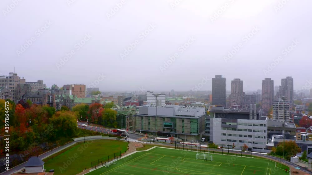 Drone moving up, over a synthetic soccer field in the middle of the city on a foggy fall morning in Montreal Drone moving up, over a synthetic soccer field in the middle of the city on a foggy fall morning in Montreal