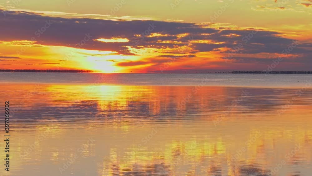 Dramatic vivid sunset over a Florida ocean bay with calm reflection Dramatic vivid sunset over a Florida ocean bay with calm reflection