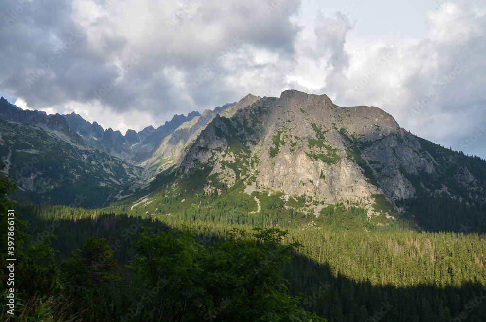 Picturesque view to rocky mountains against cloudy sky in High Tatras (Vysoke Tatry), Slovakia