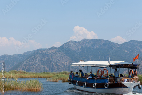 Boats with tourists floating on the river against the background of mountains