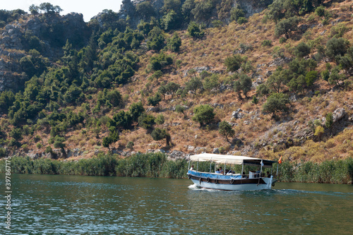 A small boat in a body of water with a mountain in the background