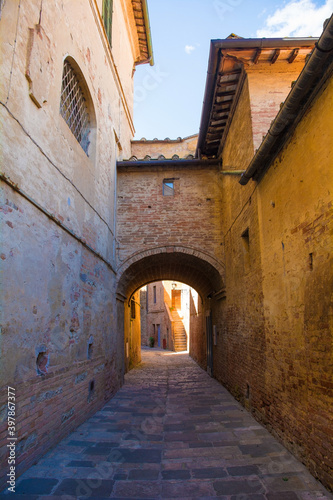 Fototapeta Naklejka Na Ścianę i Meble -  A residential alley in the historic medieval village of Buonconvento, Siena Province, Tuscany, Italy
