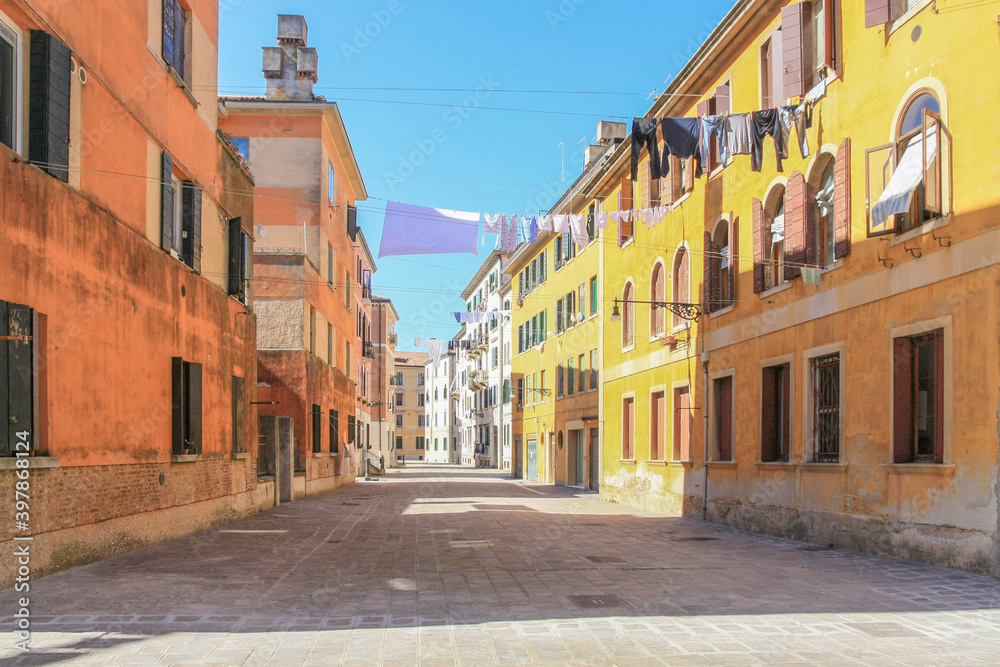 narrow street in Venice, Venezia, Italy,  laundry hung up to dry, sunshine, country customs