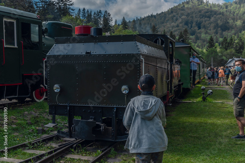 Narrow gauge railway in Majdan station with summer passengers in Poland