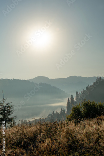 Beautiful sunrise in mountains with white fog below panorama