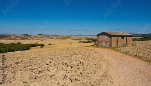 A hut in the late summer landscape in Val d'Orcia near San Quirico d'Orcia, Siena Province, Tuscany, Italy 