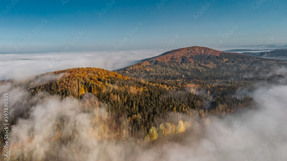 Aerial view of morning foggy landscape. Fall autumn peaceful scenery. Misty calm atmosphere. Drone photo of Czech mountains. Trees in fog. Fairy tale land.Meditation dreamy concept
