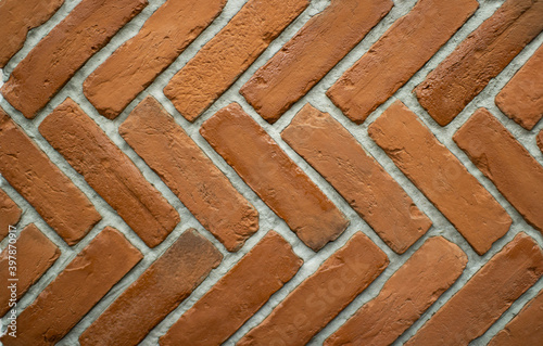Red brick wall with white seams. Textured brickwork