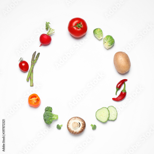 Frame of different fresh vegetables on white background, top view