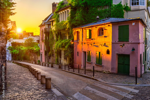 Sunset view of cozy strert in quarter Montmartre in Paris, France photo