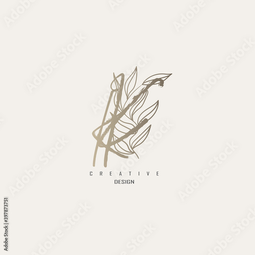 logo kk dengan warna emas, logo terinspirasi dari daun dan kuas.