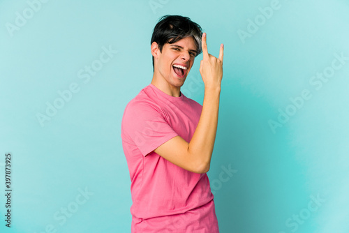 Young caucasian skinny man expressing emotions isolated on blue background