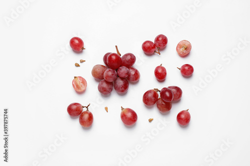 Composition with fresh ripe grapes and seeds on white background, top view
