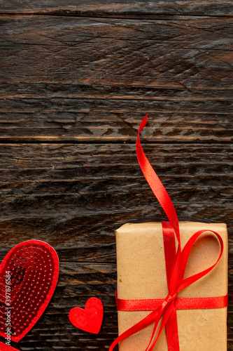 Paper craft Gift box with red ribbon bow and red hearts. Festive concept for Valentine's day, Mother's day or birthday.