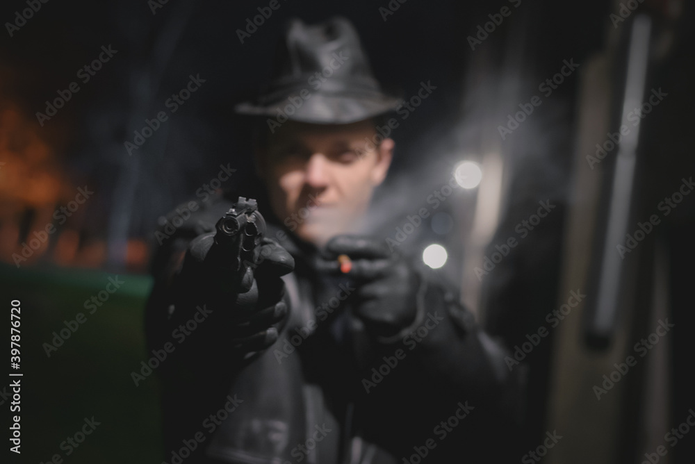 Detective agent spy is aiming by the gun.