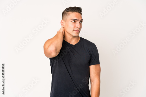 Young caucasian handsome man isolated touching back of head, thinking and making a choice.