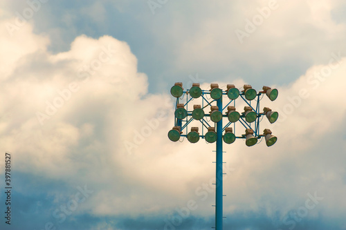Stadium lights against a cloudy sky