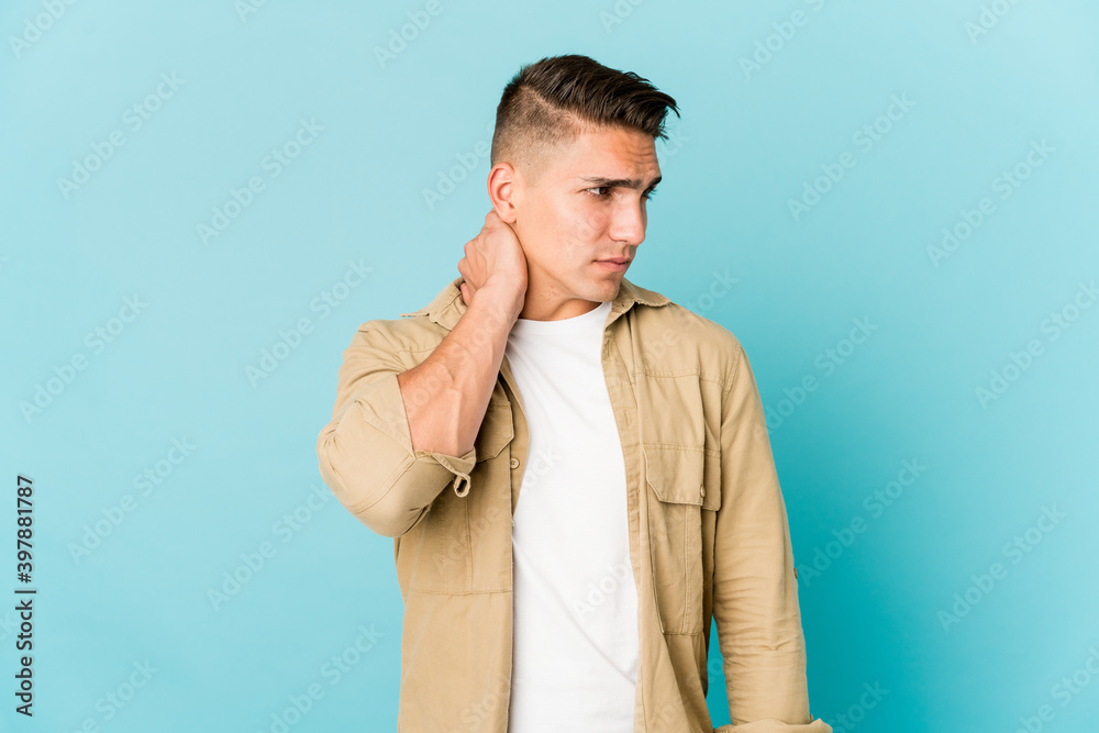 Young caucasian handsome man isolated suffering neck pain due to sedentary lifestyle. Young caucasian handsome man isolated suffering neck pain due to sedentary lifestyle.
