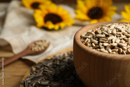 Raw sunflower seeds on table, closeup. Space for text