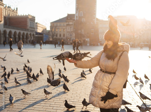 Photography Young woman and pigeons in Market Square, Krakow, Poland