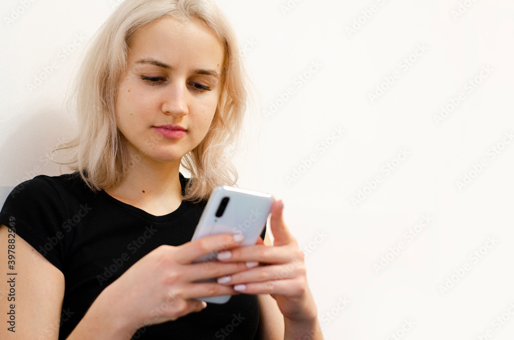 The girl reads bad news on the phone. Social networks. The girl reads bad news on the phone. Social networks.