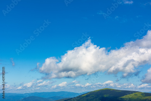 white fluffy clouds on the blue sky. beautiful nature scenery in mountains