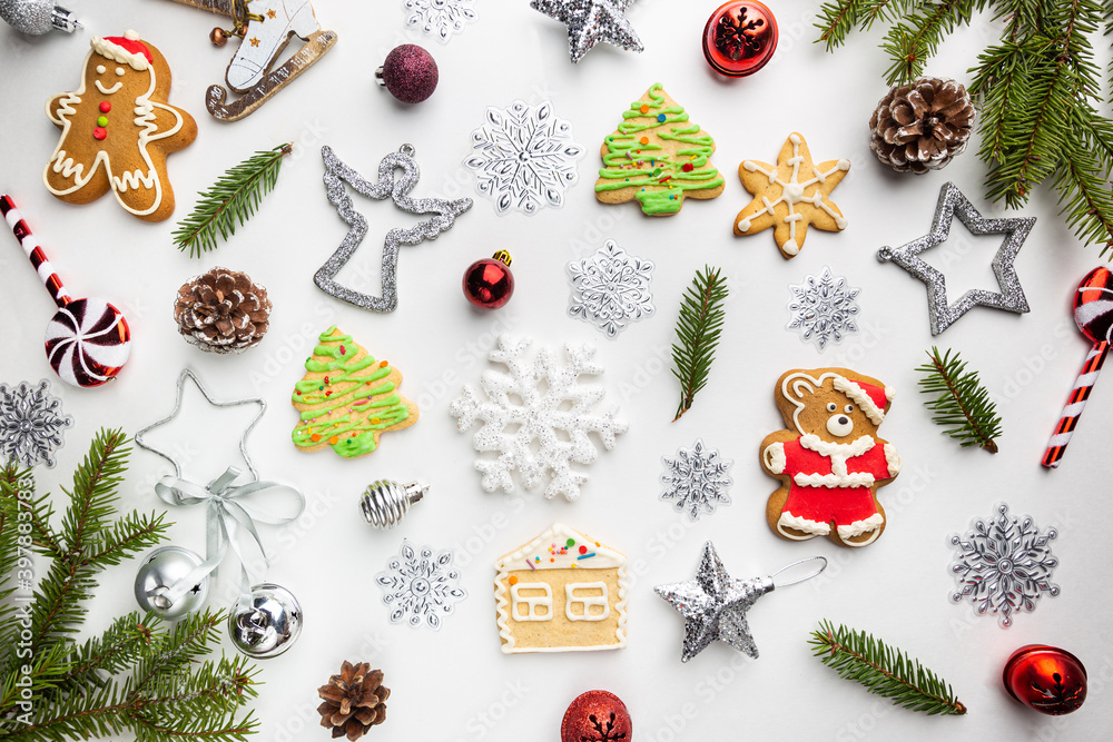 Christmas background made of winter decorations and gingerbread on white. Christmas concept. Flat lay, top view. Christmas background made of winter decorations and gingerbread on white. Christmas concept. Flat lay, top view.