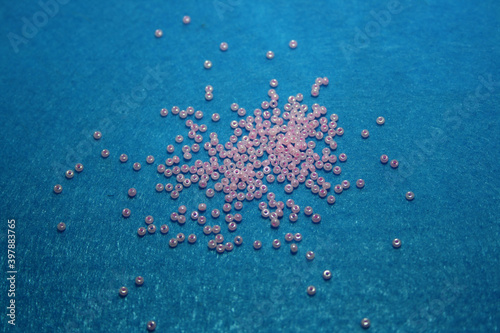 Pink beads on the blue felt background.