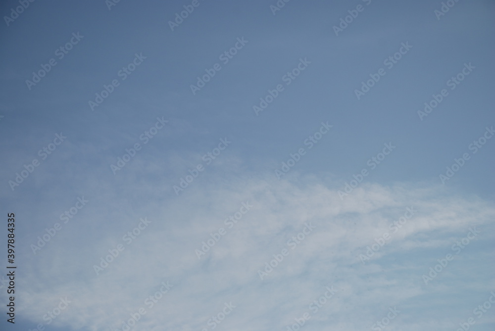 Light-blue sky with persistent clouds.
The sky is light blue with a translucent cirrus cloud.