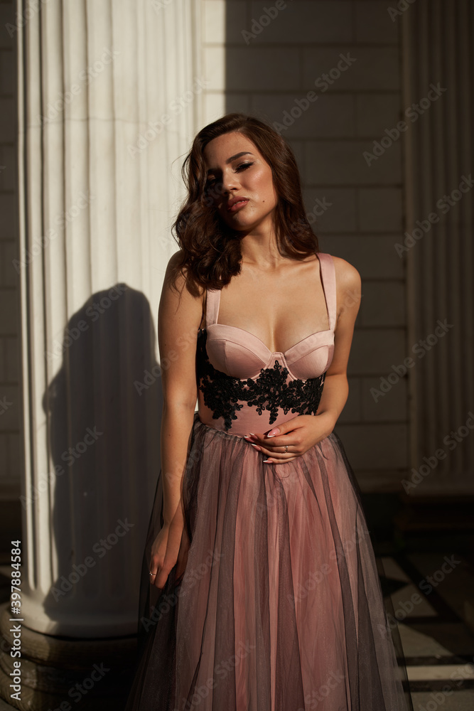 Fototapeta premium Young beautiful woman in an evening dress in the theater
