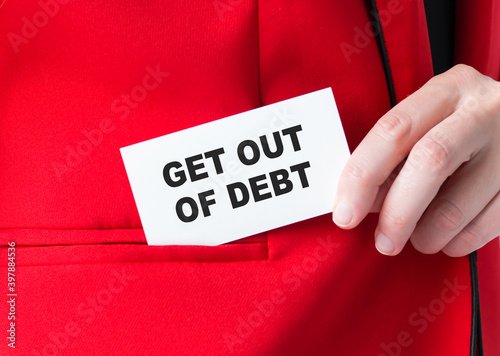 Man puts a card in his jacket pocket with the inscription GET OUT OF DEBT