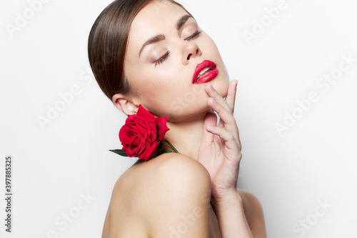 Beautiful woman naked shoulders Closed eyes rose flower luxury 