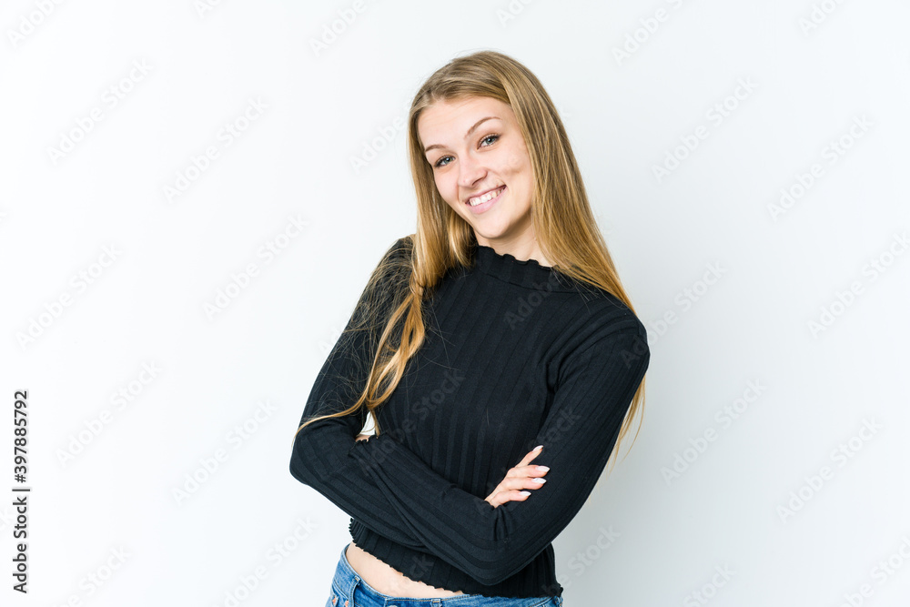 Young blonde woman isolated on white background who feels confident, crossing arms with determination. Young blonde woman isolated on white background who feels confident, crossing arms with determination.