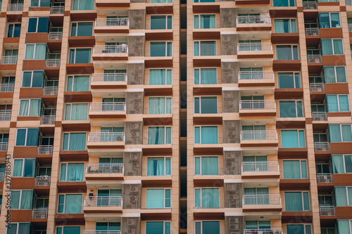 Magnificent building in warm colors and lots of balconies, background