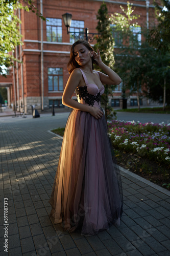 Young beautiful woman in an evening dress in the theater