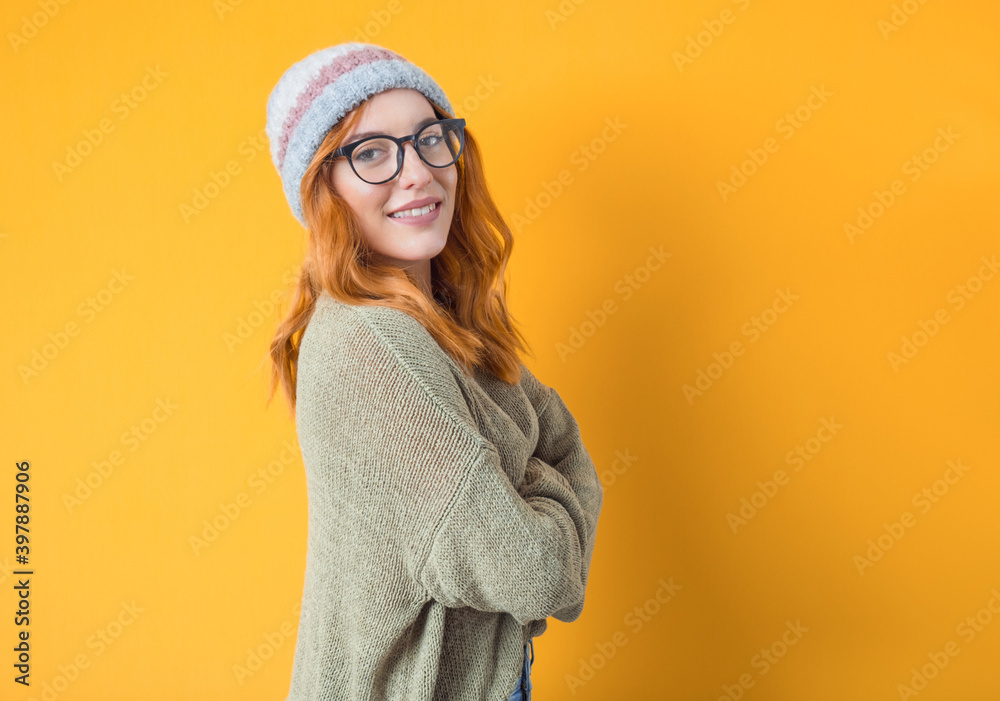 Young woman with smile expression standing,half length, isolated on yellow background. Happy trendy girl. Studio shot Young woman with smile expression standing,half length, isolated on yellow background. Happy trendy girl. Studio shot