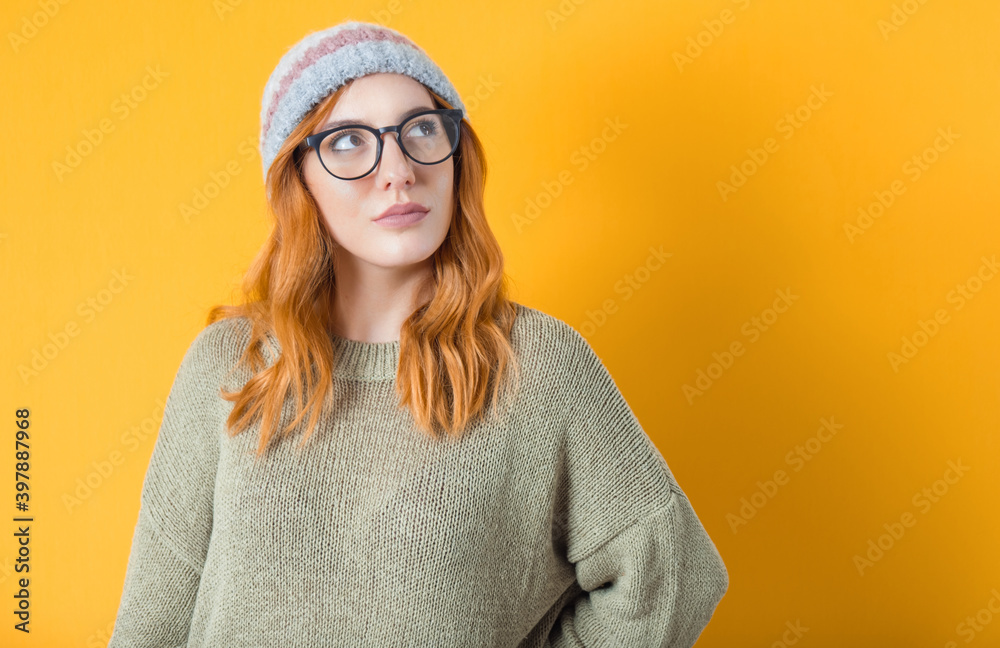 Young woman looking up to blank space - copyspace, isolated on yellow background. Thinking beautiful girl. Close-up. Young woman looking up to blank space - copyspace, isolated on yellow background. Thinking beautiful girl. Close-up.