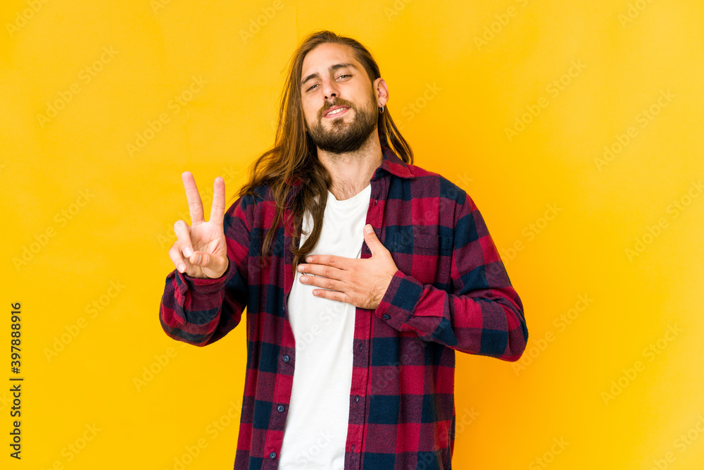 Young man with long hair look taking an oath, putting hand on chest. Young man with long hair look taking an oath, putting hand on chest.