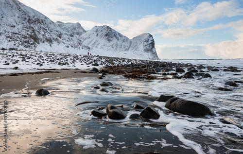 snow covered mountains in the Lofoten archipelago, Norway at Unstad beach photo