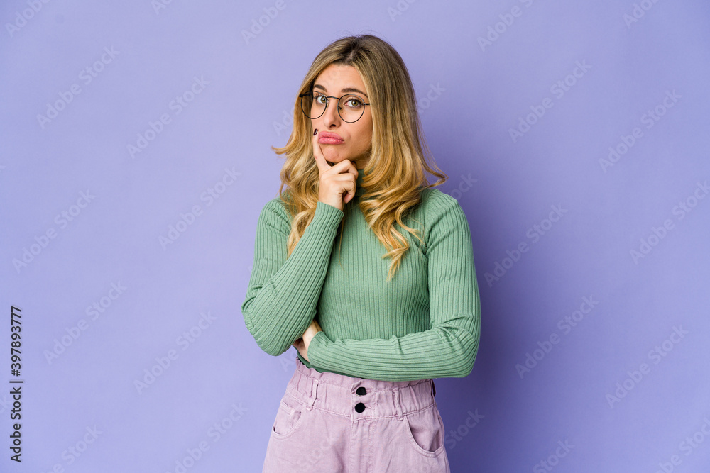 Young caucasian blonde woman unhappy looking in camera with sarcastic expression. Young caucasian blonde woman unhappy looking in camera with sarcastic expression.
