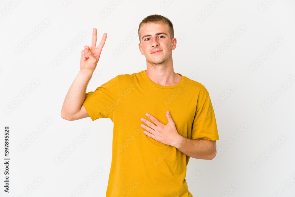 Young caucasian handsome man taking an oath, putting hand on chest. Young caucasian handsome man taking an oath, putting hand on chest.