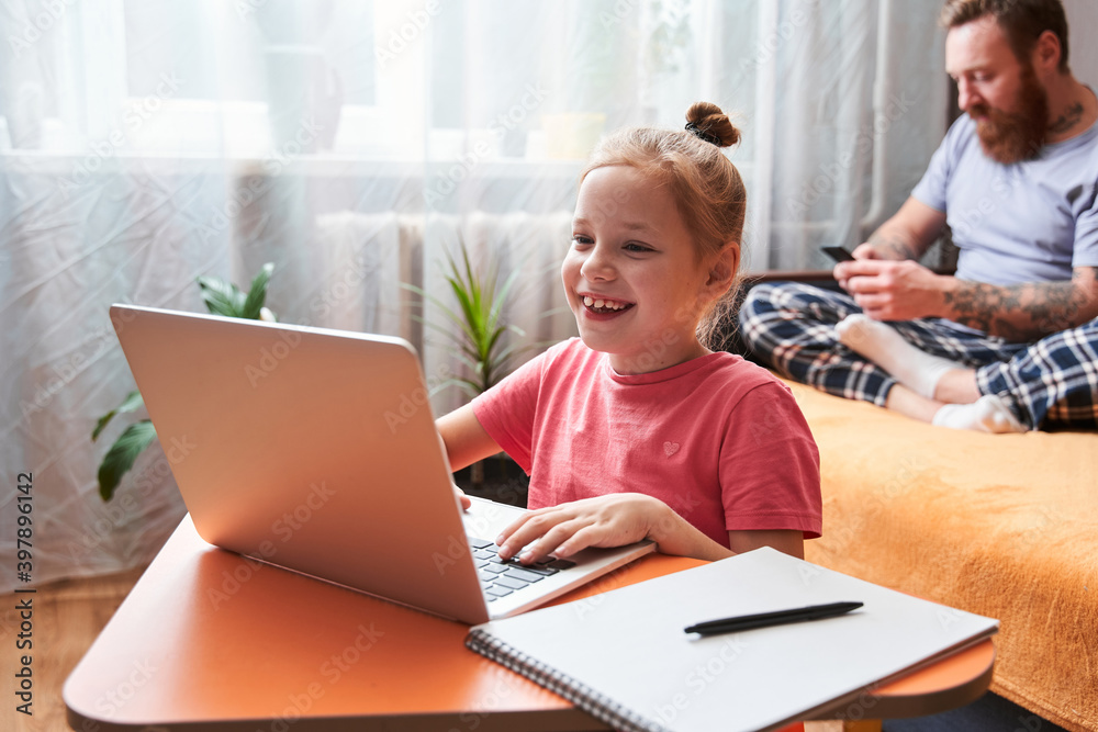 Kid using laptop at home at self isolation Kid using laptop at home at self isolation