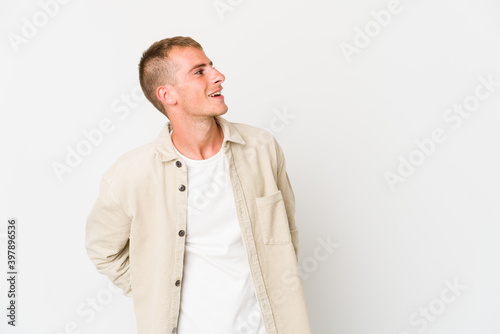 Young caucasian handsome man relaxed and happy laughing, neck stretched showing teeth.