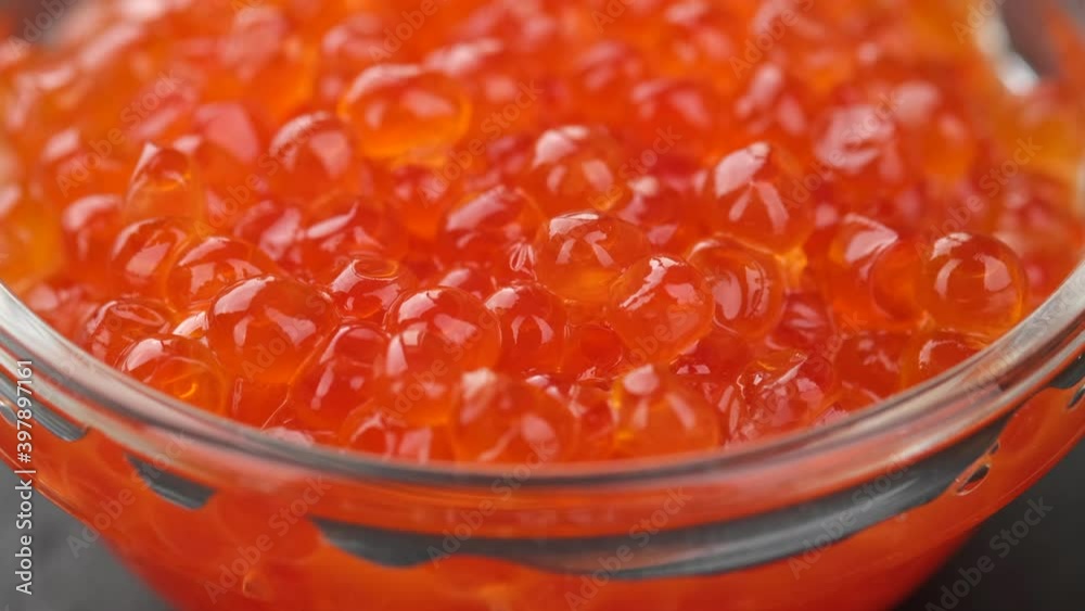 red caviar in glass jar close up rotating. salmon caviar macro red caviar in glass jar close up rotating. salmon caviar macro