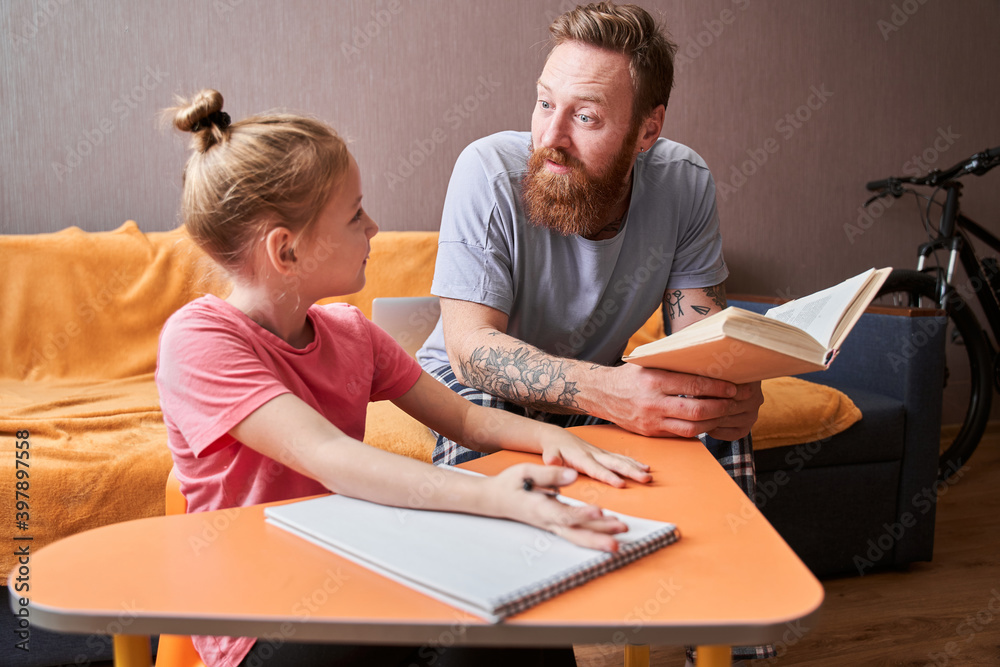 Father and small daughter looking at each other Father and small daughter looking at each other