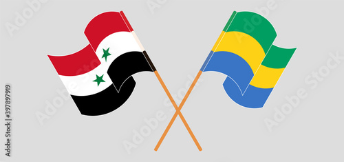 Crossed and waving flags of Syria and Gabon