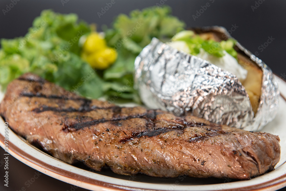 Fresh off the grill tritip steak served with all the familiar baked potato and vegetable sides.