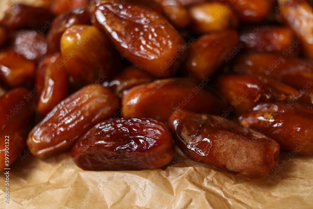 Close up of date fruits placed on brown paper